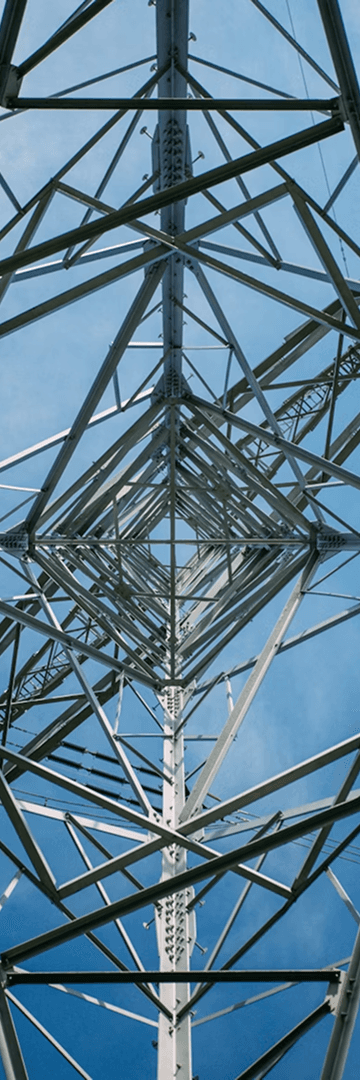 Low-angle transmission tower against blue sky, paired with lime accent panel